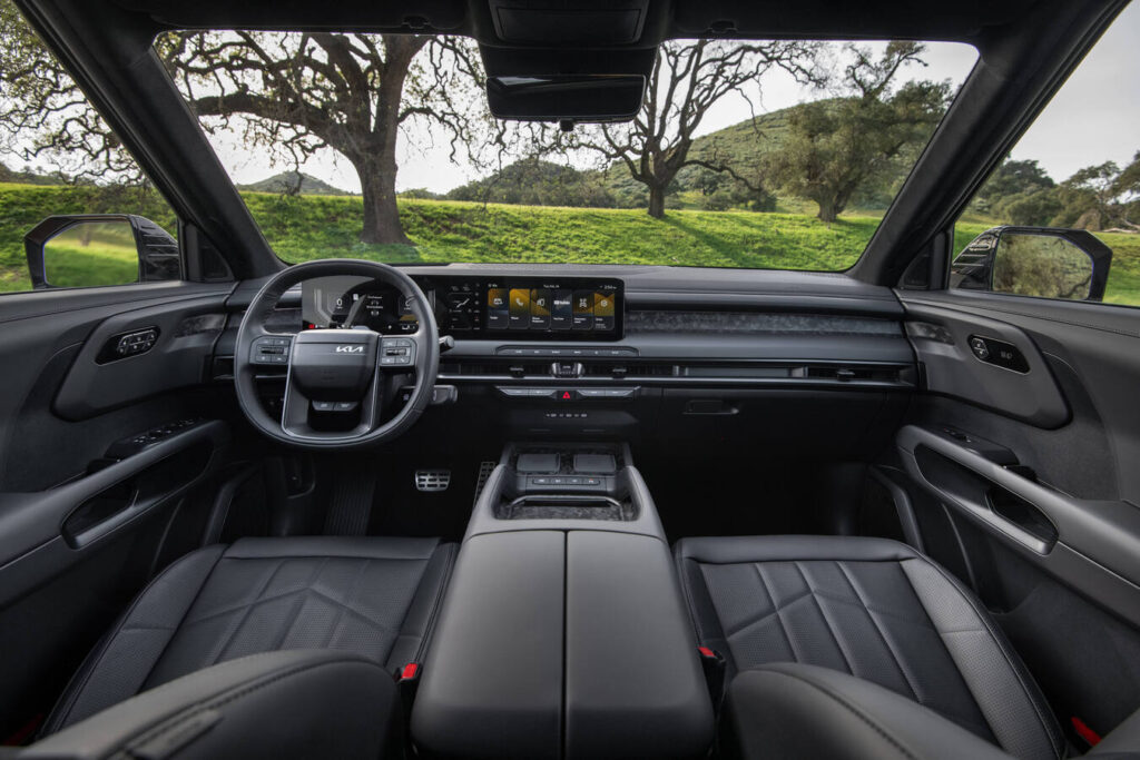 2027 Kia Telluride interior with dual 12.3-inch displays and a center console grab handle
