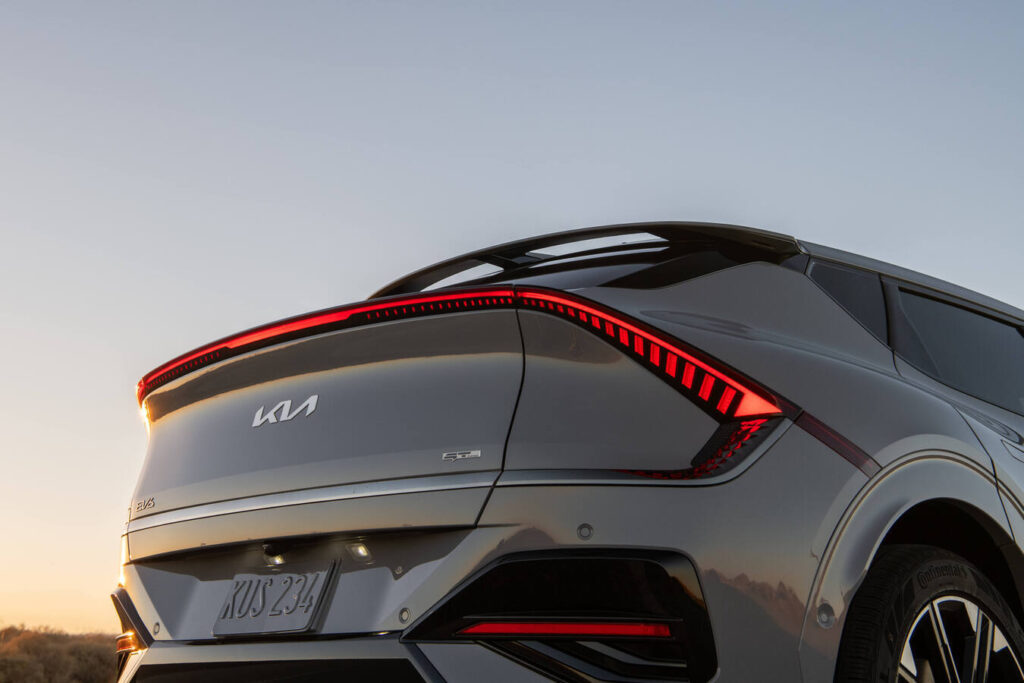 Rear view of a 2027 Kia EV6 at dusk