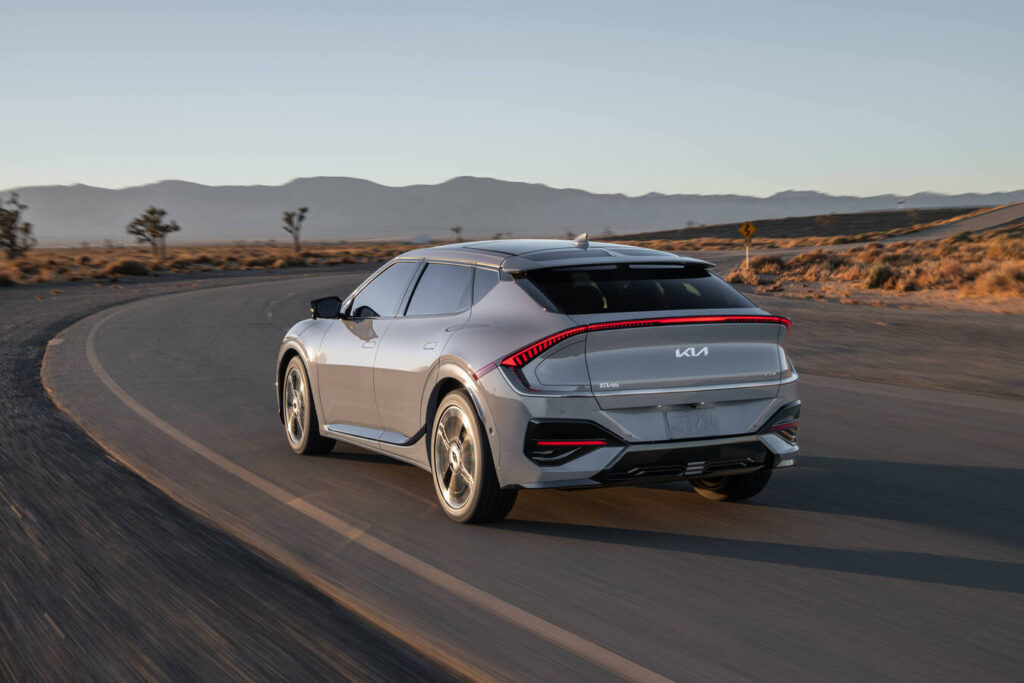 2027 Kia EV6 rounding a bend on a desert road