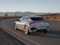 2027 Kia EV6 rounding a bend on a desert road