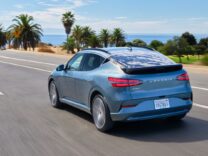 2026 Genesis GV60 driving along a coastal road